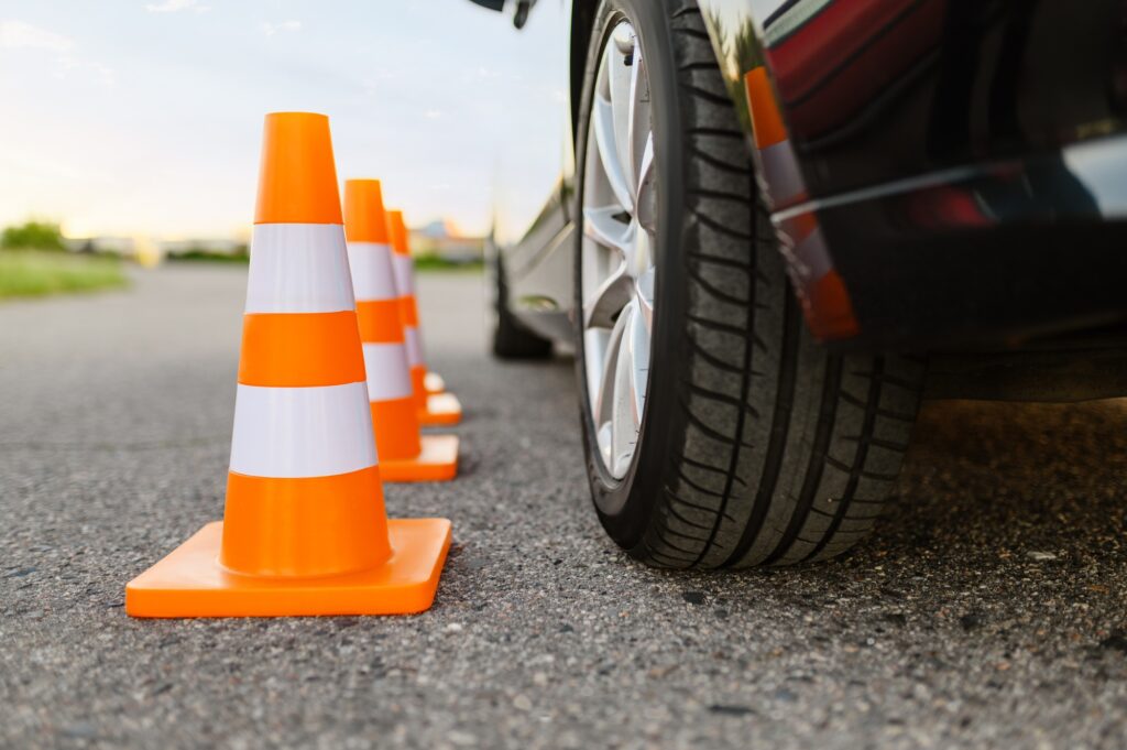 Car and traffic cones, driving school concept