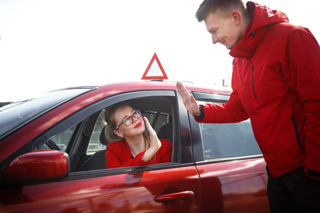 Driving instructor and woman student in examination car.