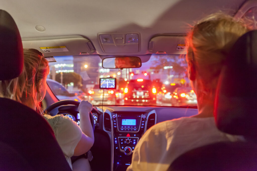 a couple of women driving in a car