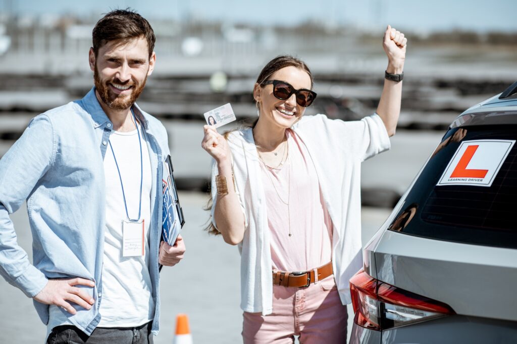 Instructor with student at the driver's school outdooors