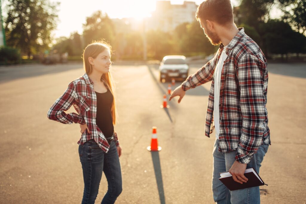 Male instructor and female student, driving school