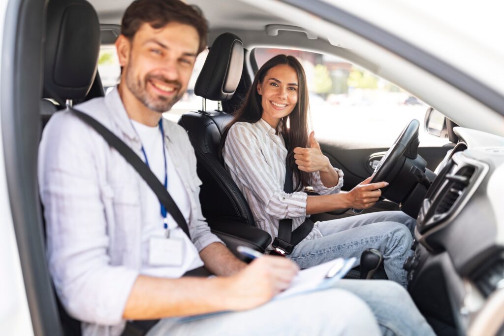 Man instructor examinating brunette lady student in driving school