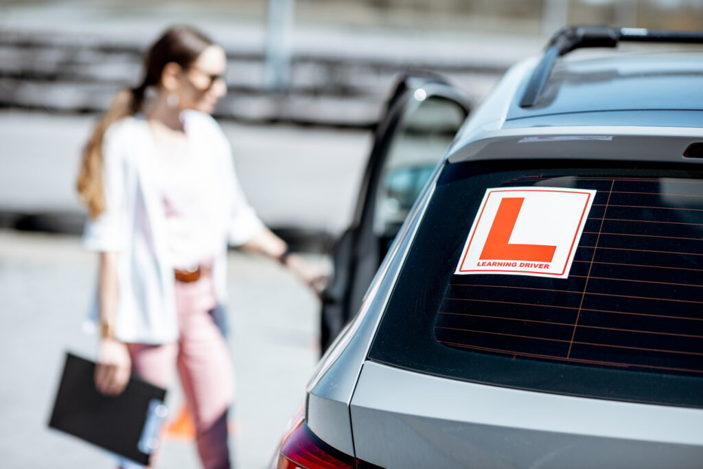 Learning sign on the car with female driver